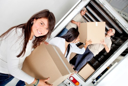 Staff assessing manual handling risks during a removal